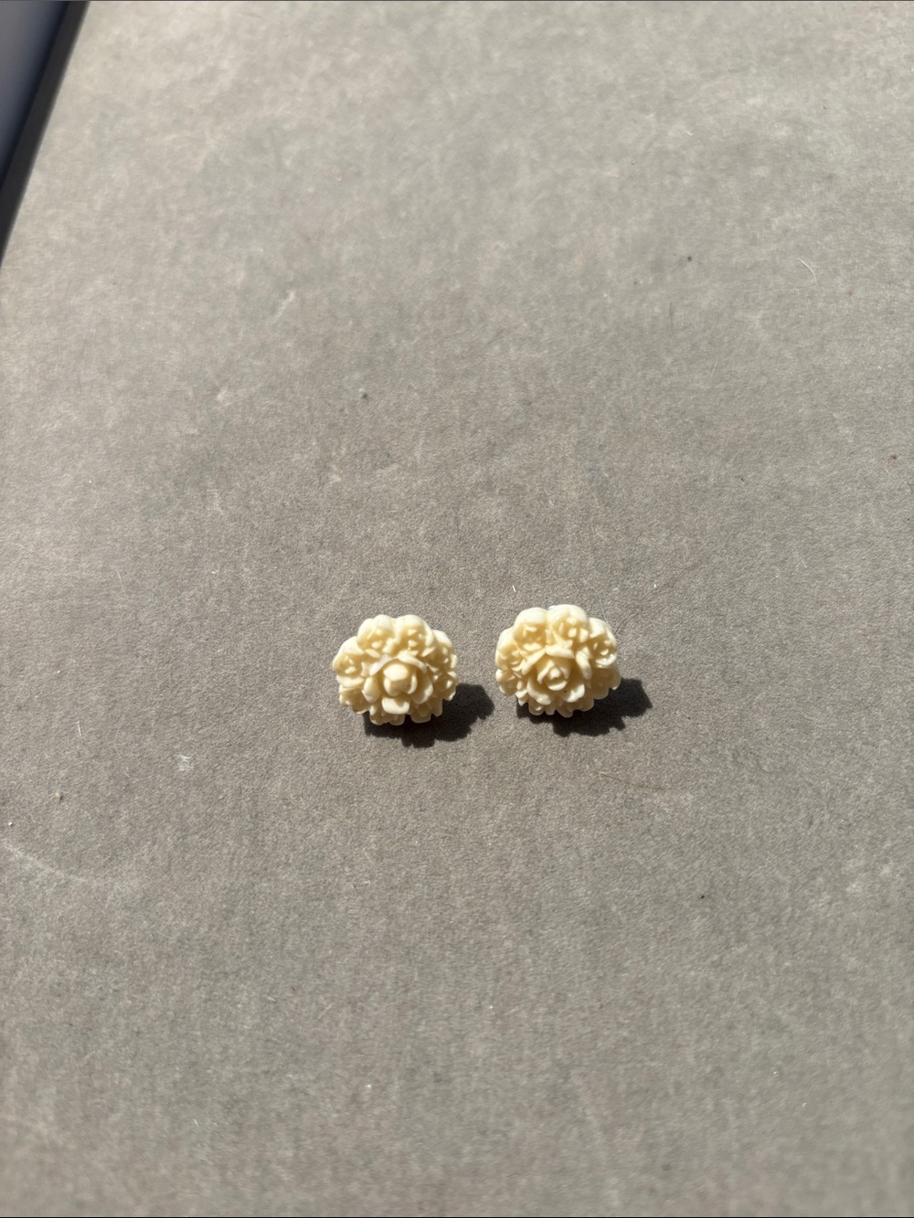 Earrings ivory color rose appearance.